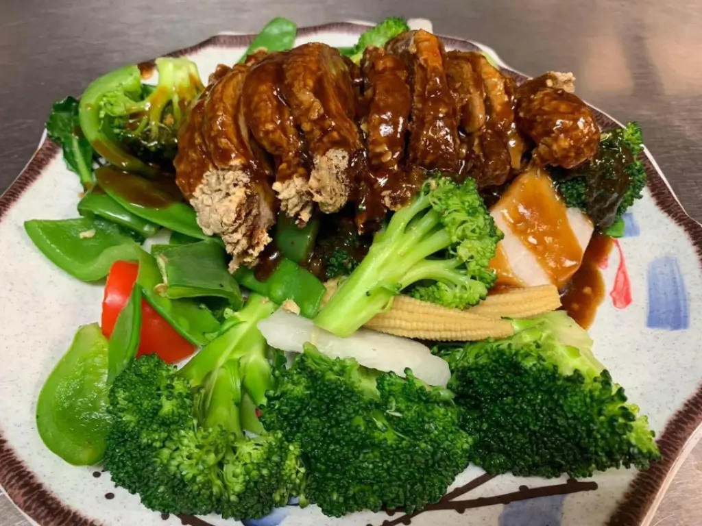 Glazed pork ribs served with assorted fresh vegetables at Red Mango Asian Cuisine Restaurant in Stratham