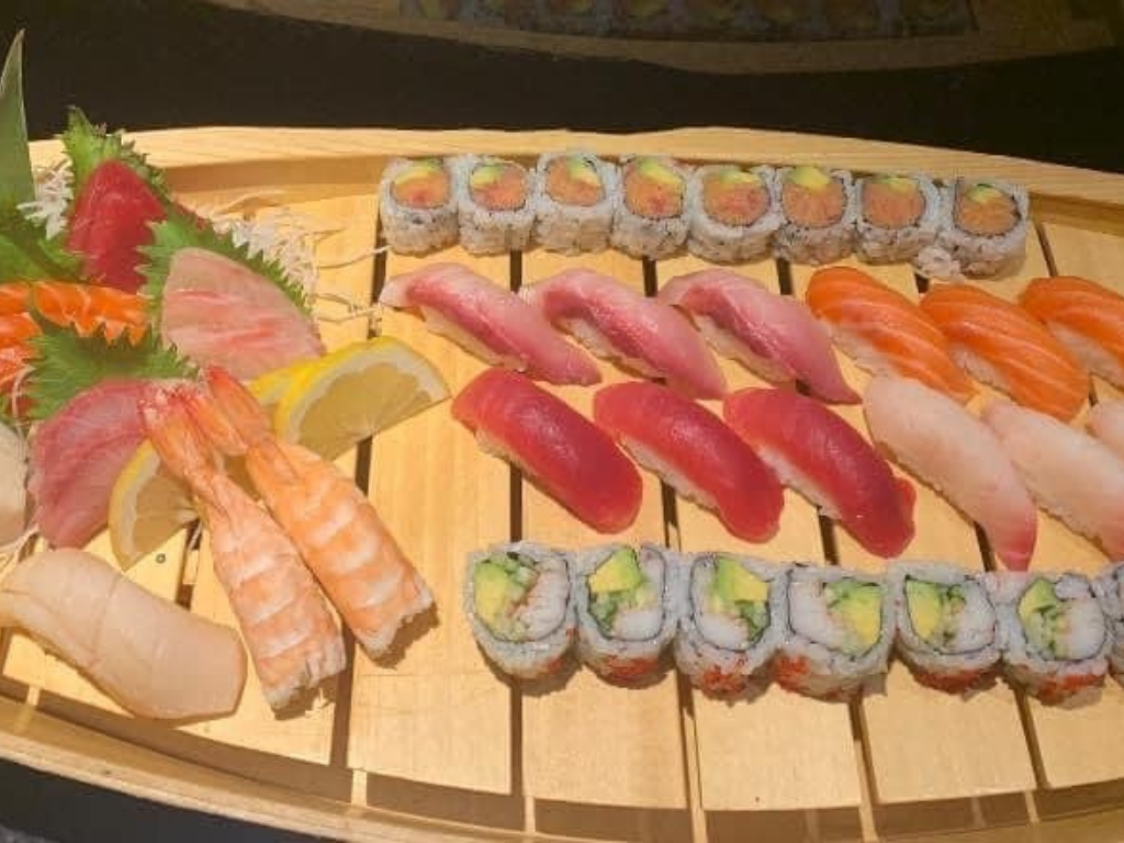Mixed sashimi (tuna, salmon, shrimp) paired with sushi rolls at Red Mango Asian Cuisine Restaurant in Stratham